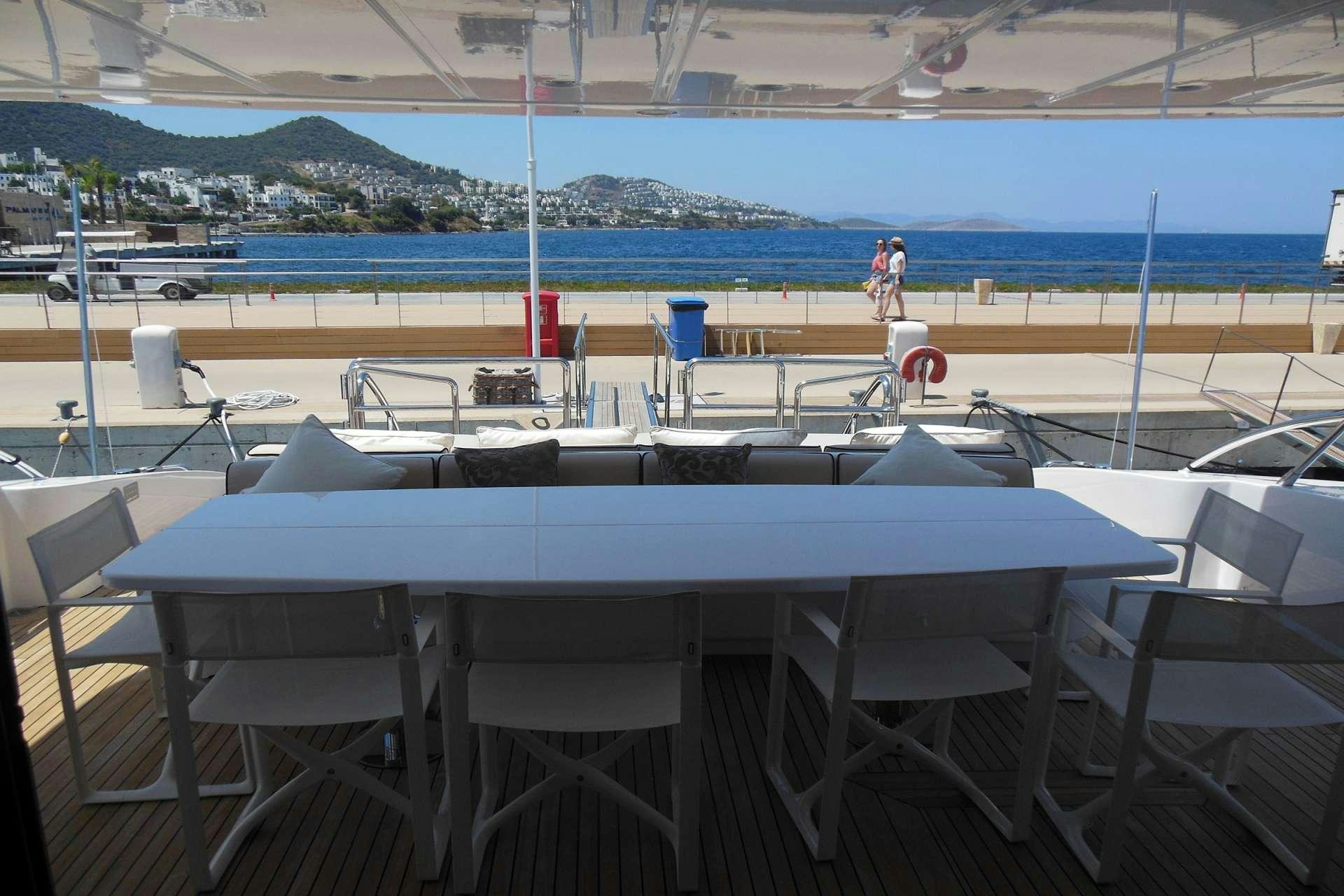 a pool with chairs and tables aboard WHITE PEARL Yacht for Charter