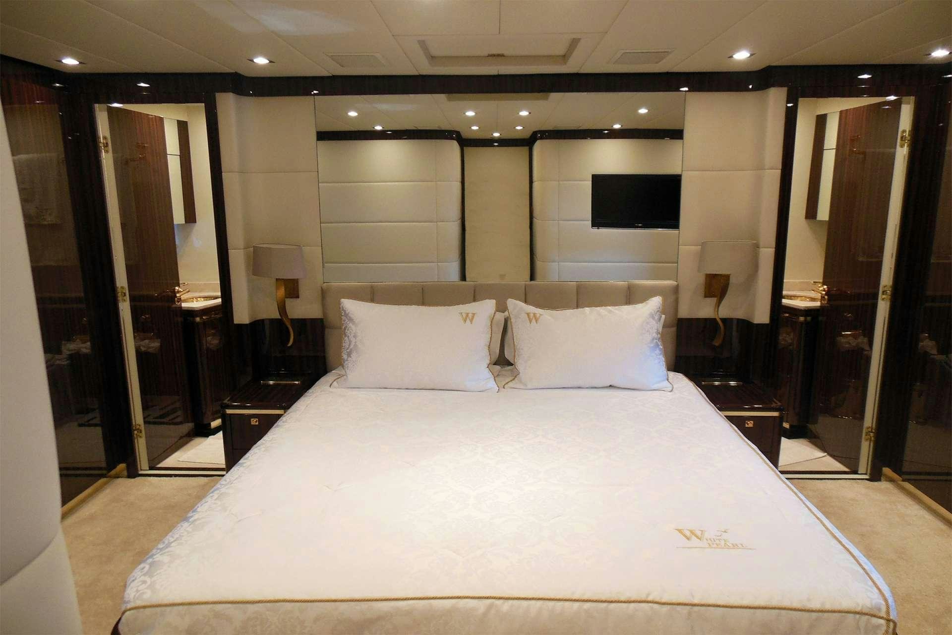 a bed with white sheets aboard WHITE PEARL Yacht for Charter