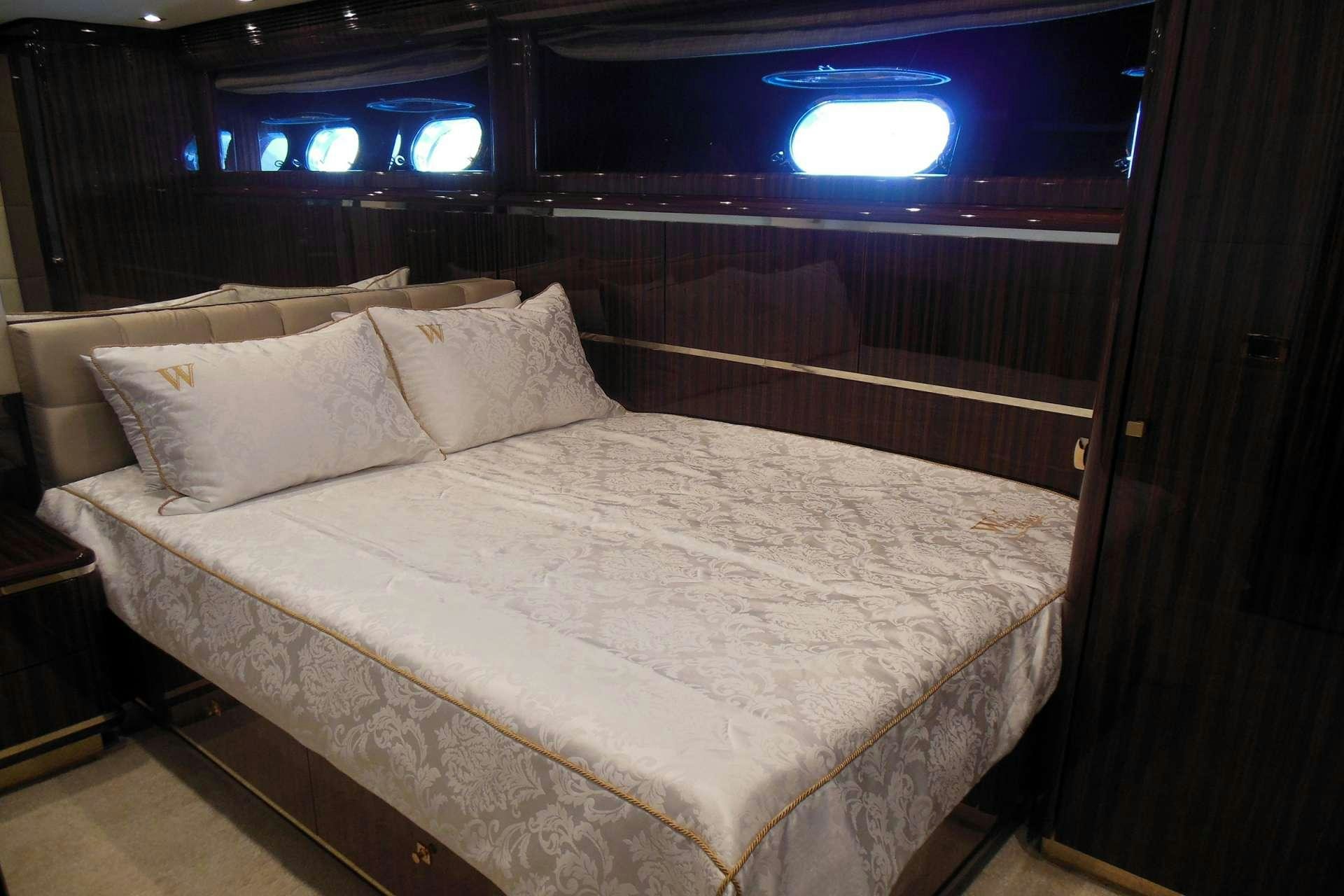 a bed with white sheets aboard WHITE PEARL Yacht for Charter