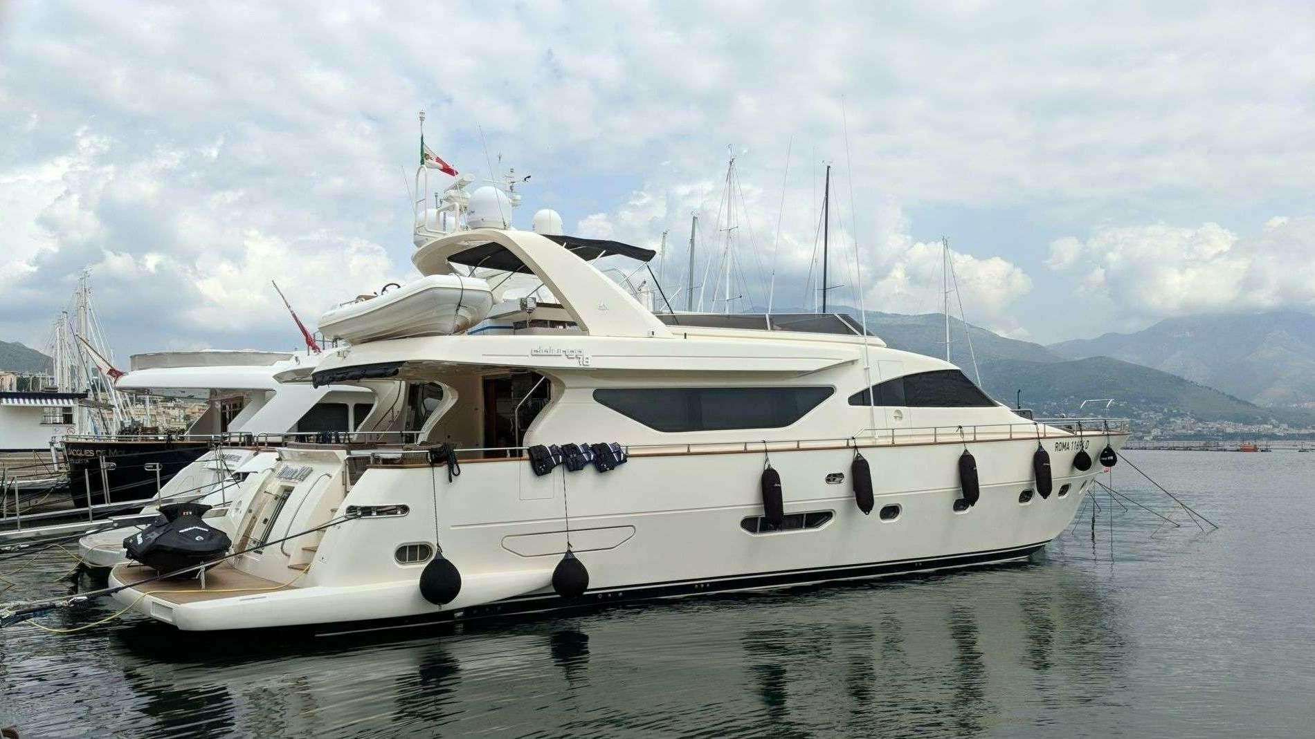 a white yacht docked aboard ARMA VII Yacht for Charter
