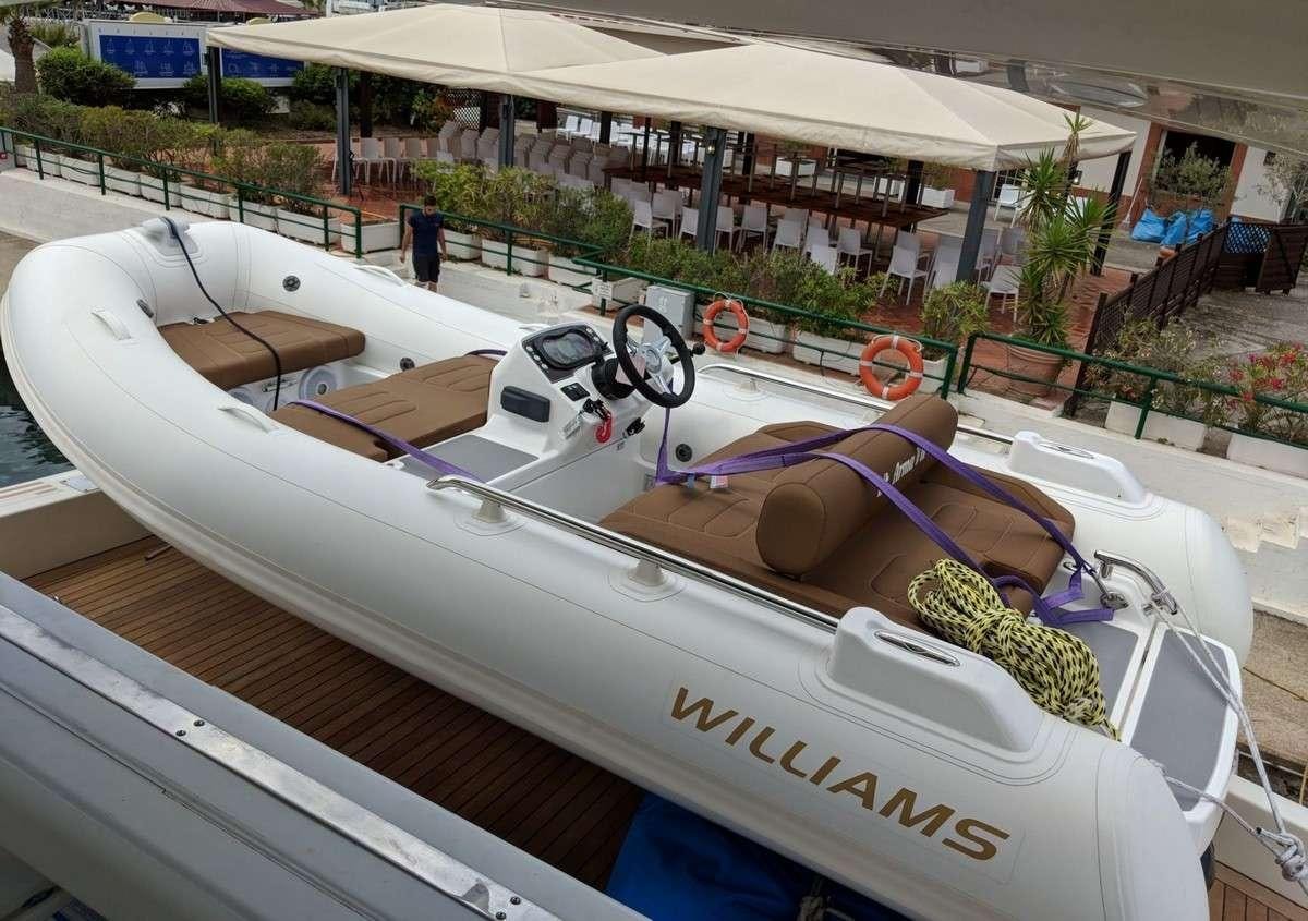 a white boat with a rope tied to it aboard ARMA VII Yacht for Charter