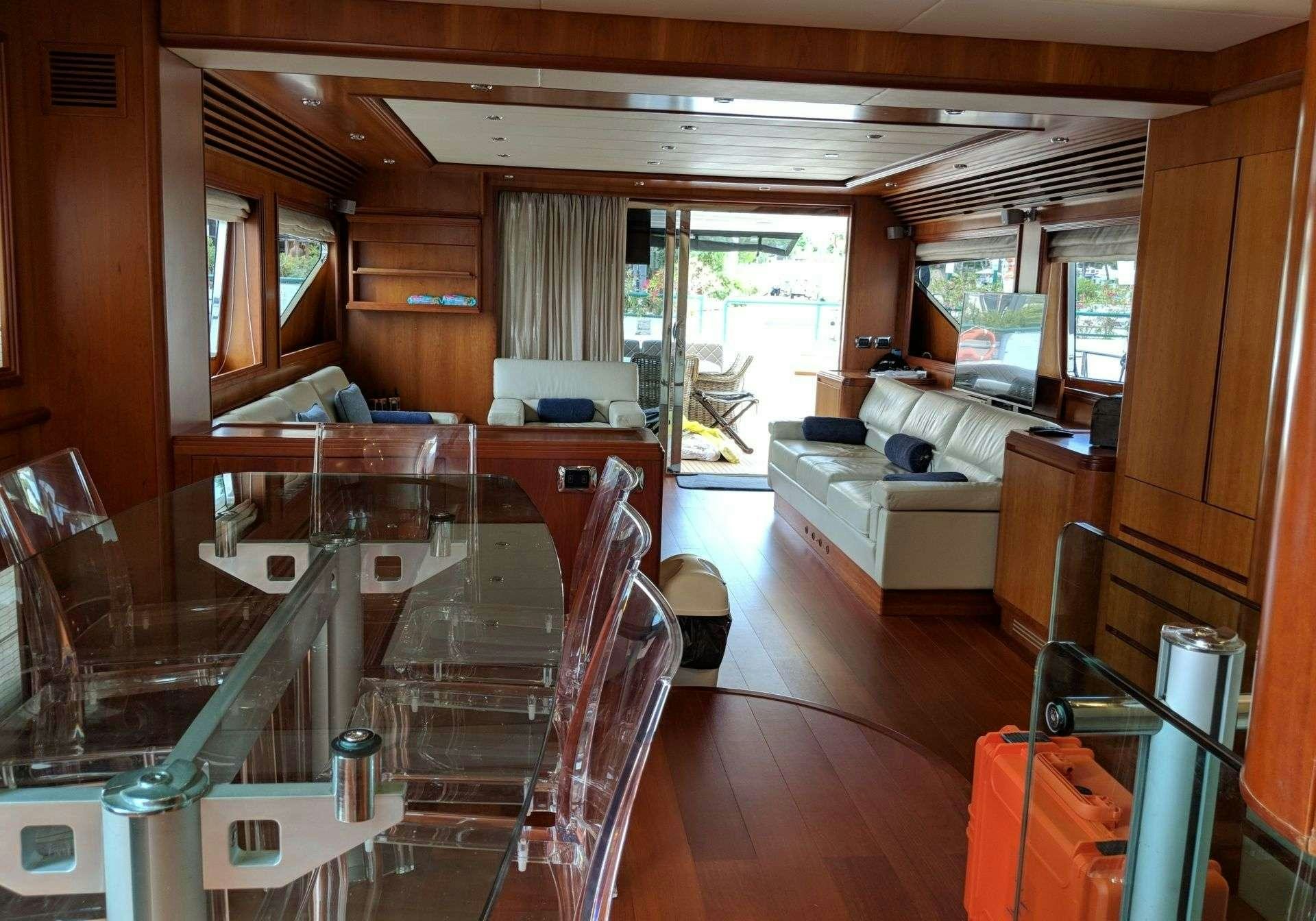 a room with a table and chairs aboard ARMA VII Yacht for Charter