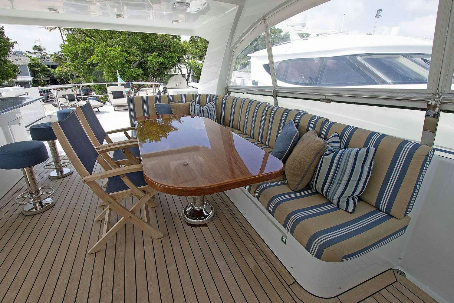 a table and chairs on a deck aboard JUS CHILL'N Yacht for Charter