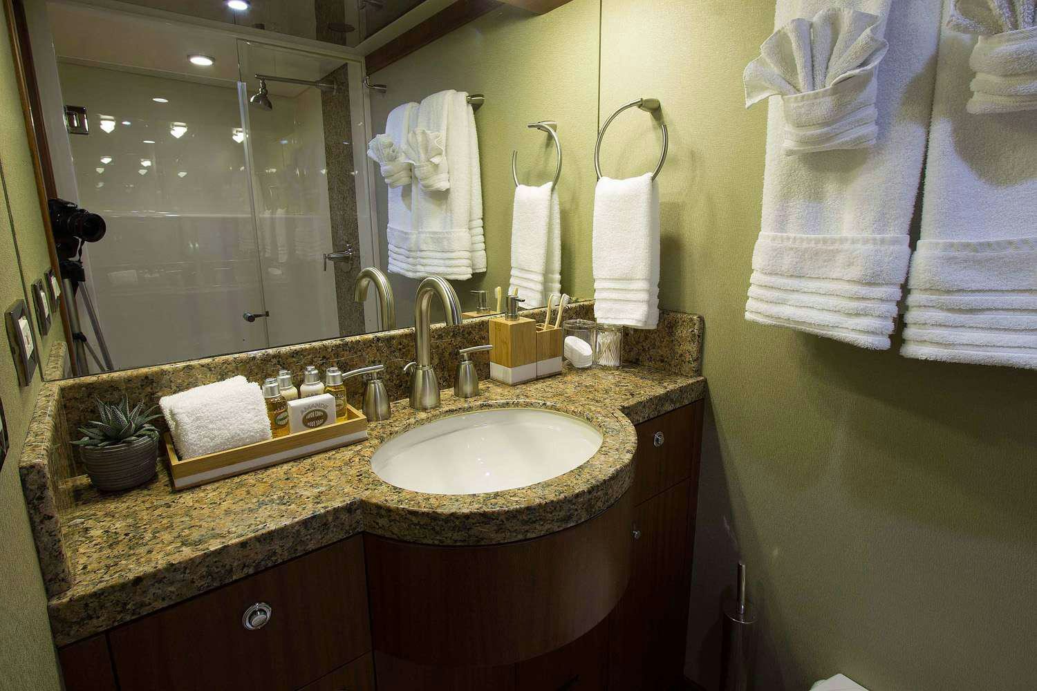 a bathroom with a countertop sink and towels aboard JUS CHILL'N Yacht for Charter