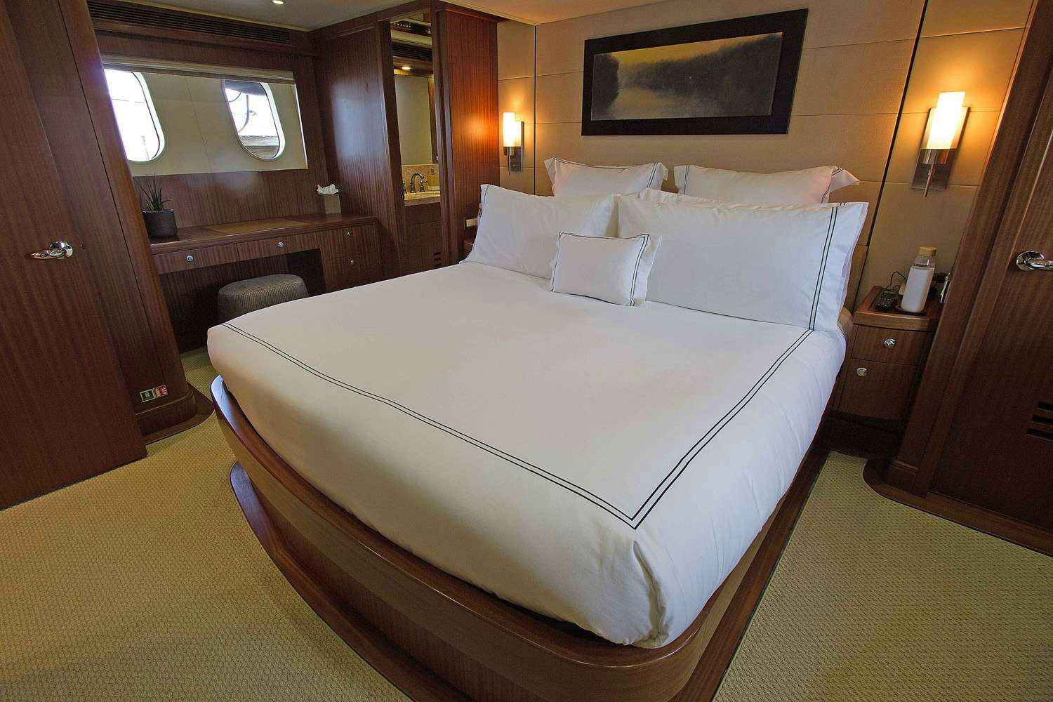 a bed with white sheets aboard JUS CHILL'N Yacht for Charter
