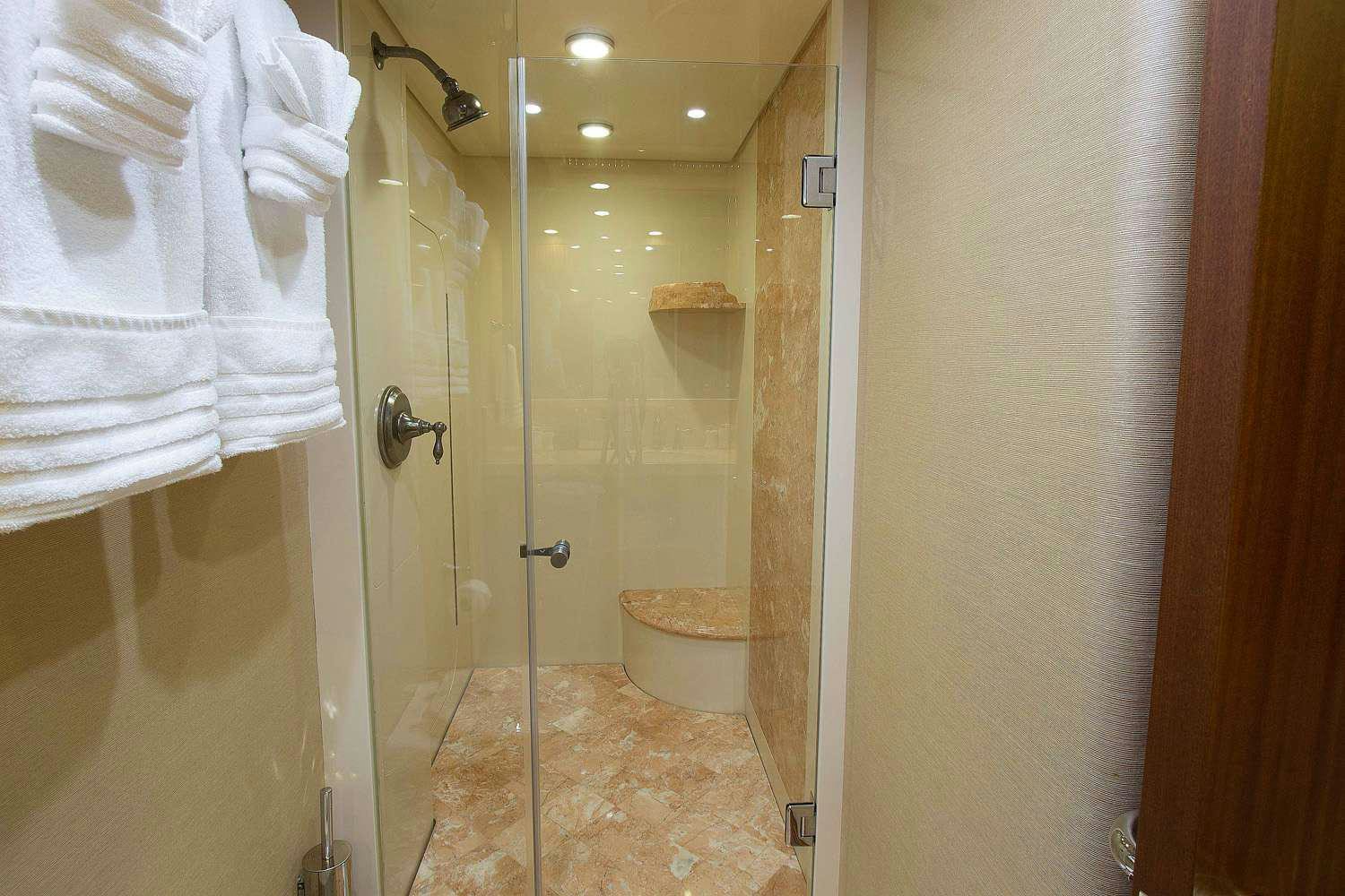 a bathroom with a glass shower aboard JUS CHILL'N Yacht for Charter