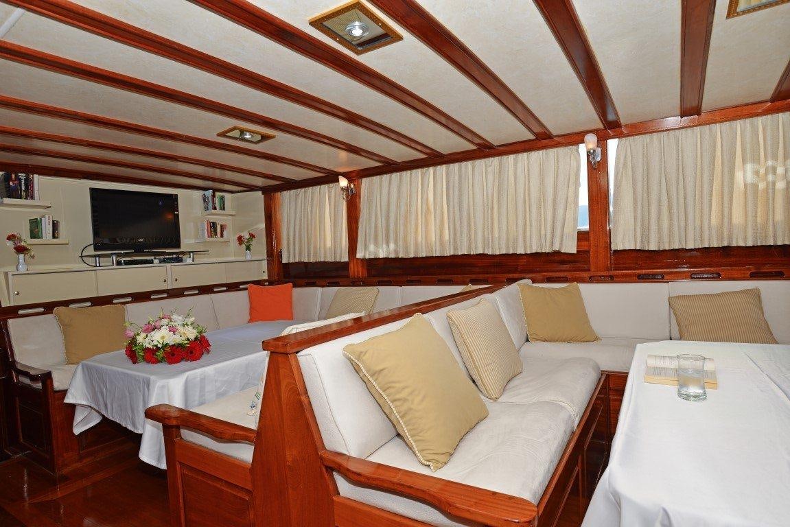 a room with a bed and a table aboard HOLIDAY X Yacht for Charter