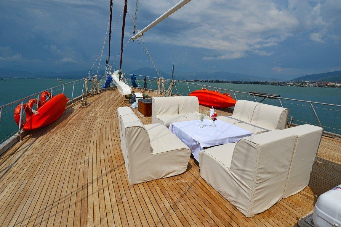 a deck with white beds on it aboard HOLIDAY X Yacht for Charter