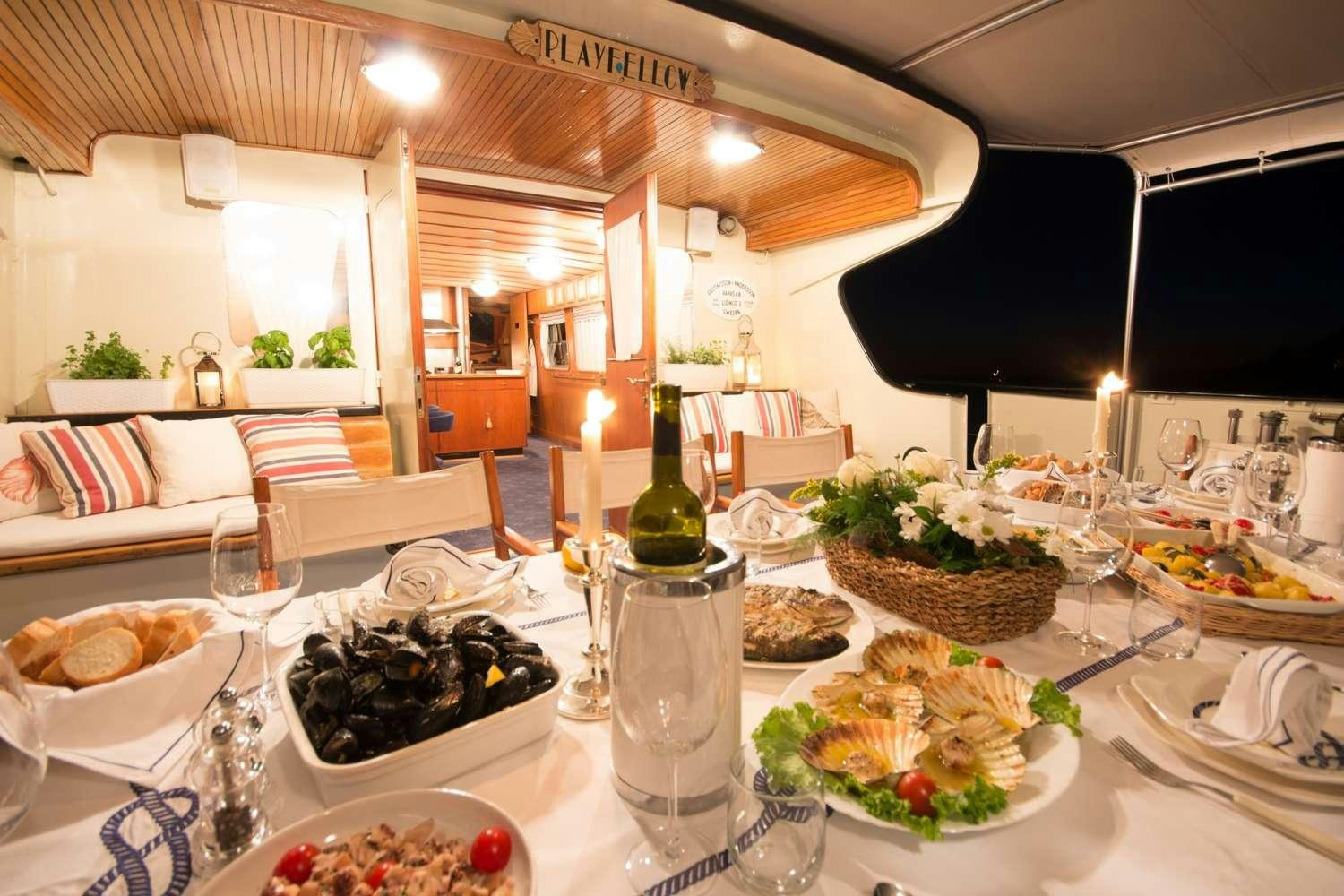 a table with food and wine aboard Play Fellow Yacht for Charter