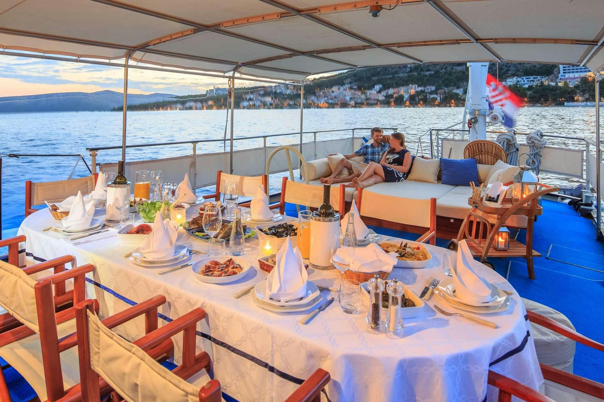 a table set for a dinner aboard Play Fellow Yacht for Charter