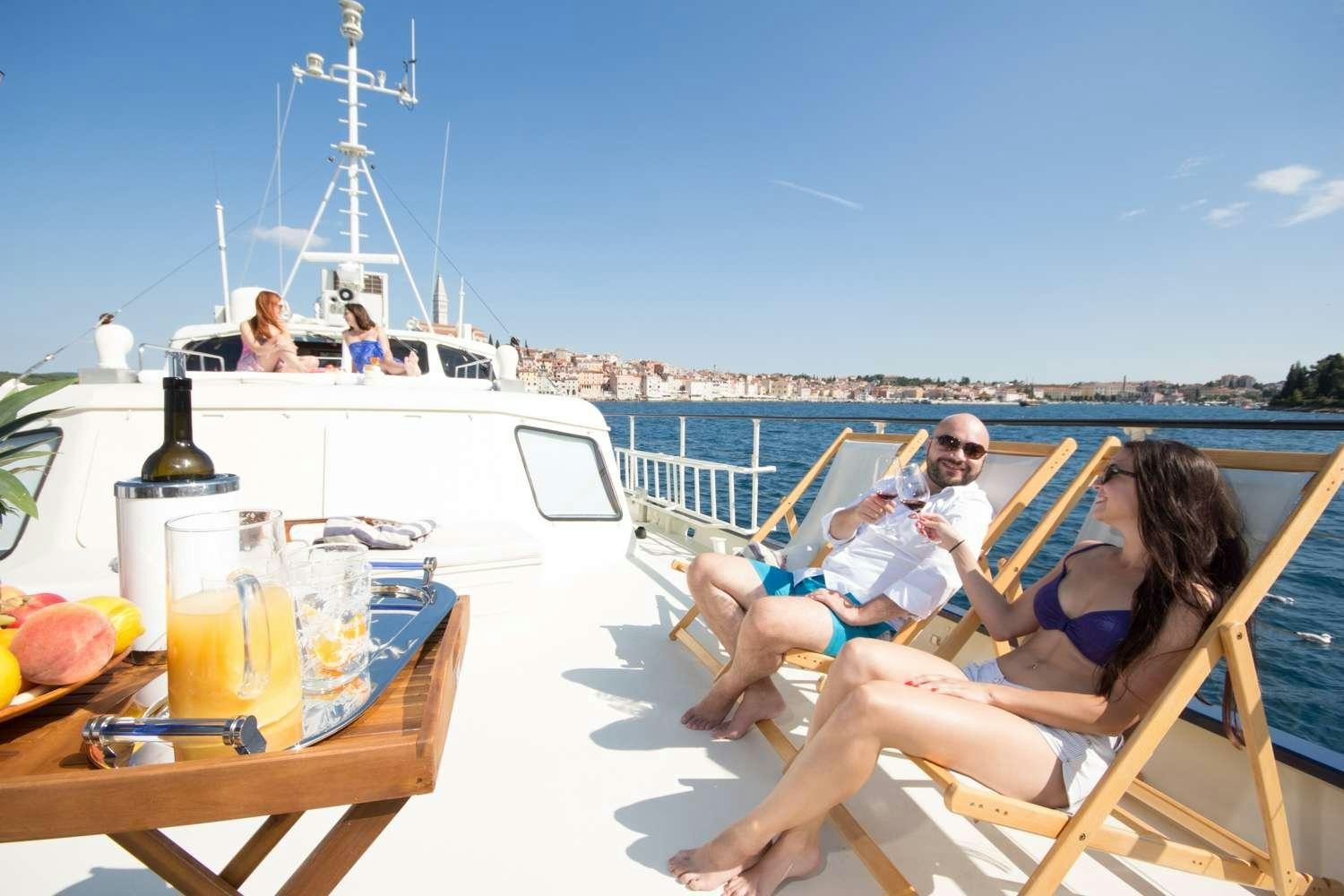 a group of people sitting on a boat aboard Play Fellow Yacht for Charter