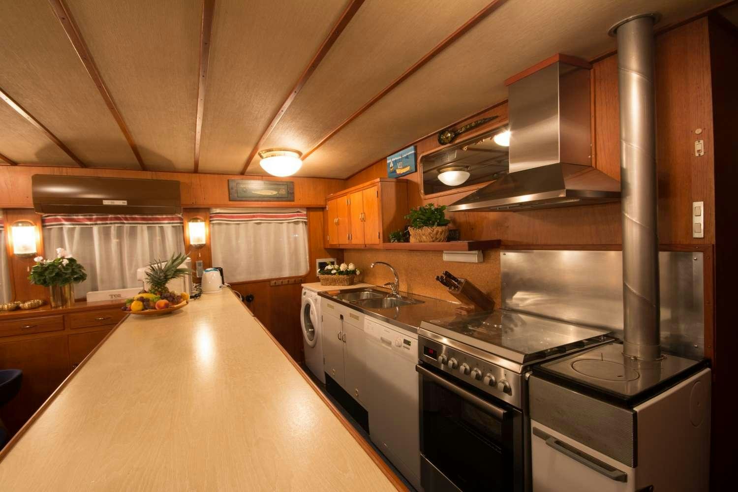 a kitchen with a large island aboard Play Fellow Yacht for Charter