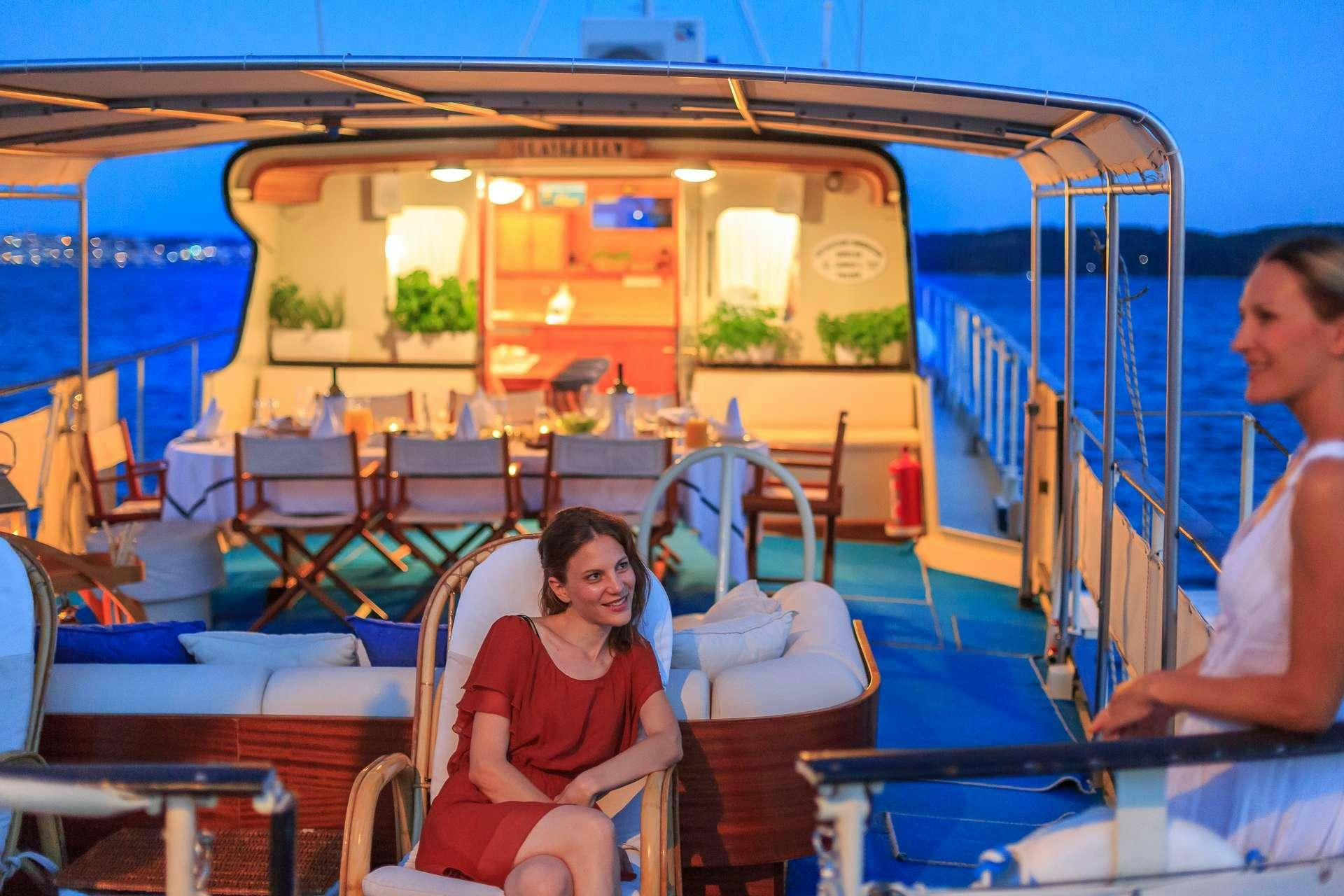 a man sitting on a boat aboard Play Fellow Yacht for Charter