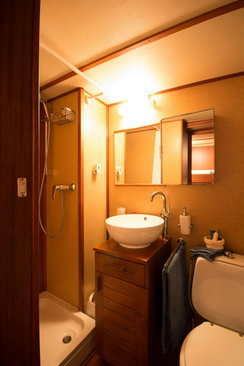 a bathroom with a sink and toilet aboard Play Fellow Yacht for Charter