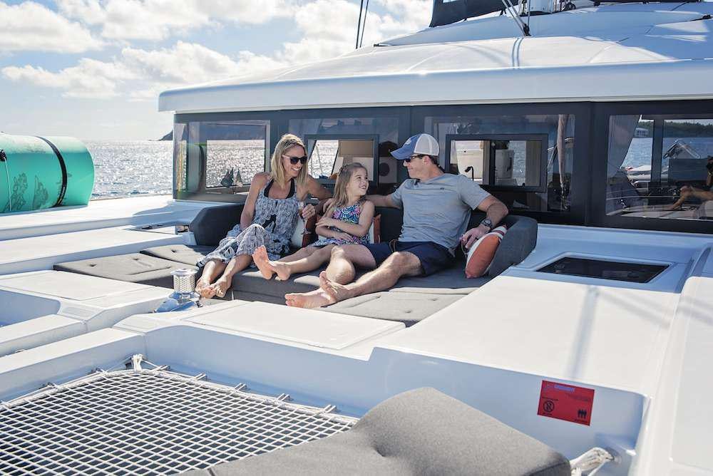 a man and woman and a child sitting on a boat aboard ISLAND HOPPIN' Yacht for Charter