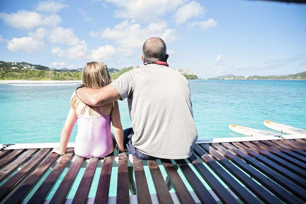 a person and a girl on a boat looking at the water aboard ISLAND HOPPIN' Yacht for Charter
