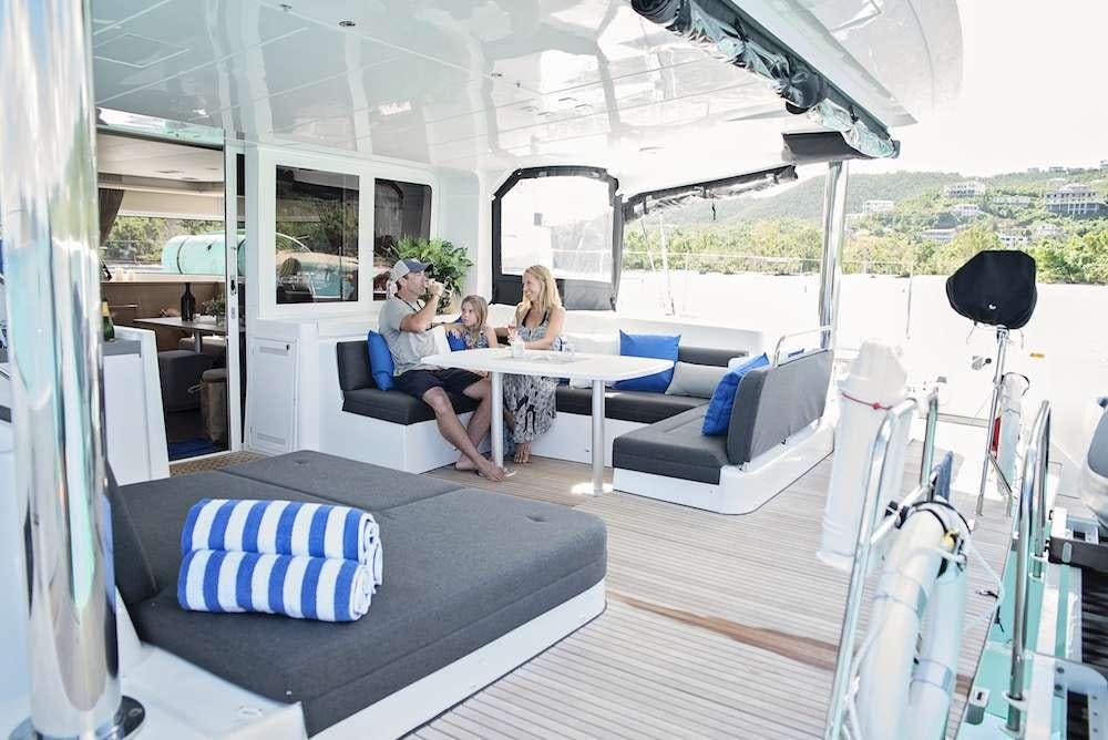 a group of people sitting around a table in a tent aboard ISLAND HOPPIN' Yacht for Charter