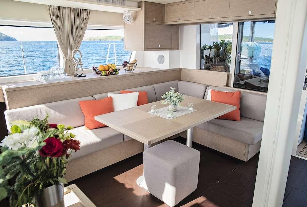 a living room with a table and chairs aboard ISLAND HOPPIN' Yacht for Charter