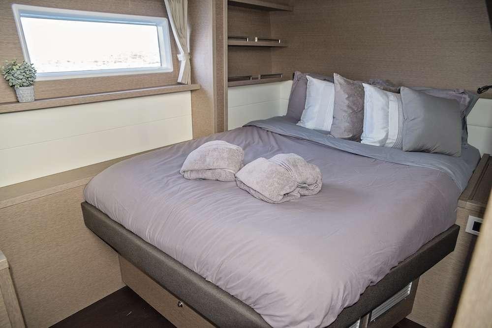 a bed with a pillow and blanket aboard ISLAND HOPPIN' Yacht for Charter