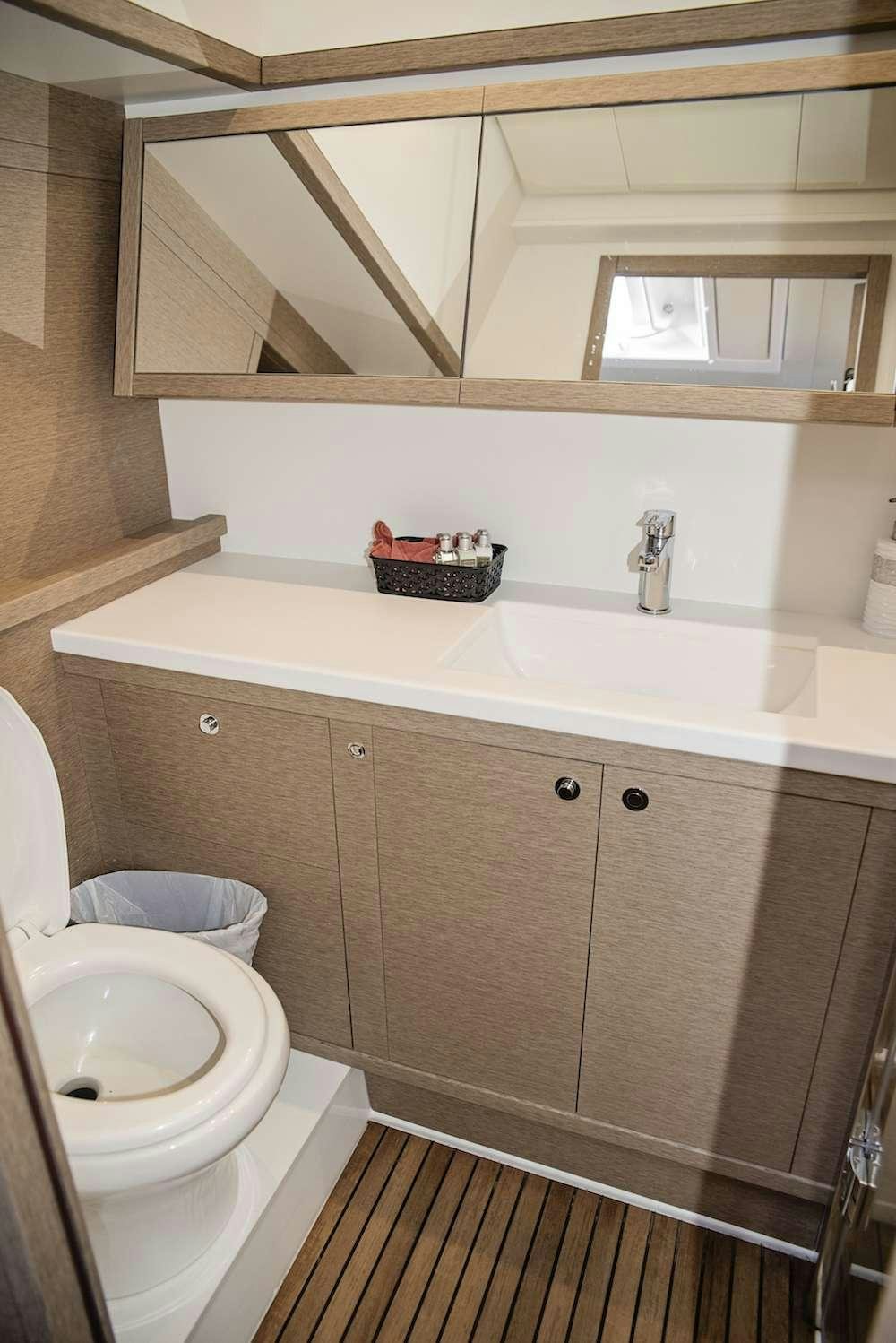 a bathroom with a sink and a toilet aboard ISLAND HOPPIN' Yacht for Charter