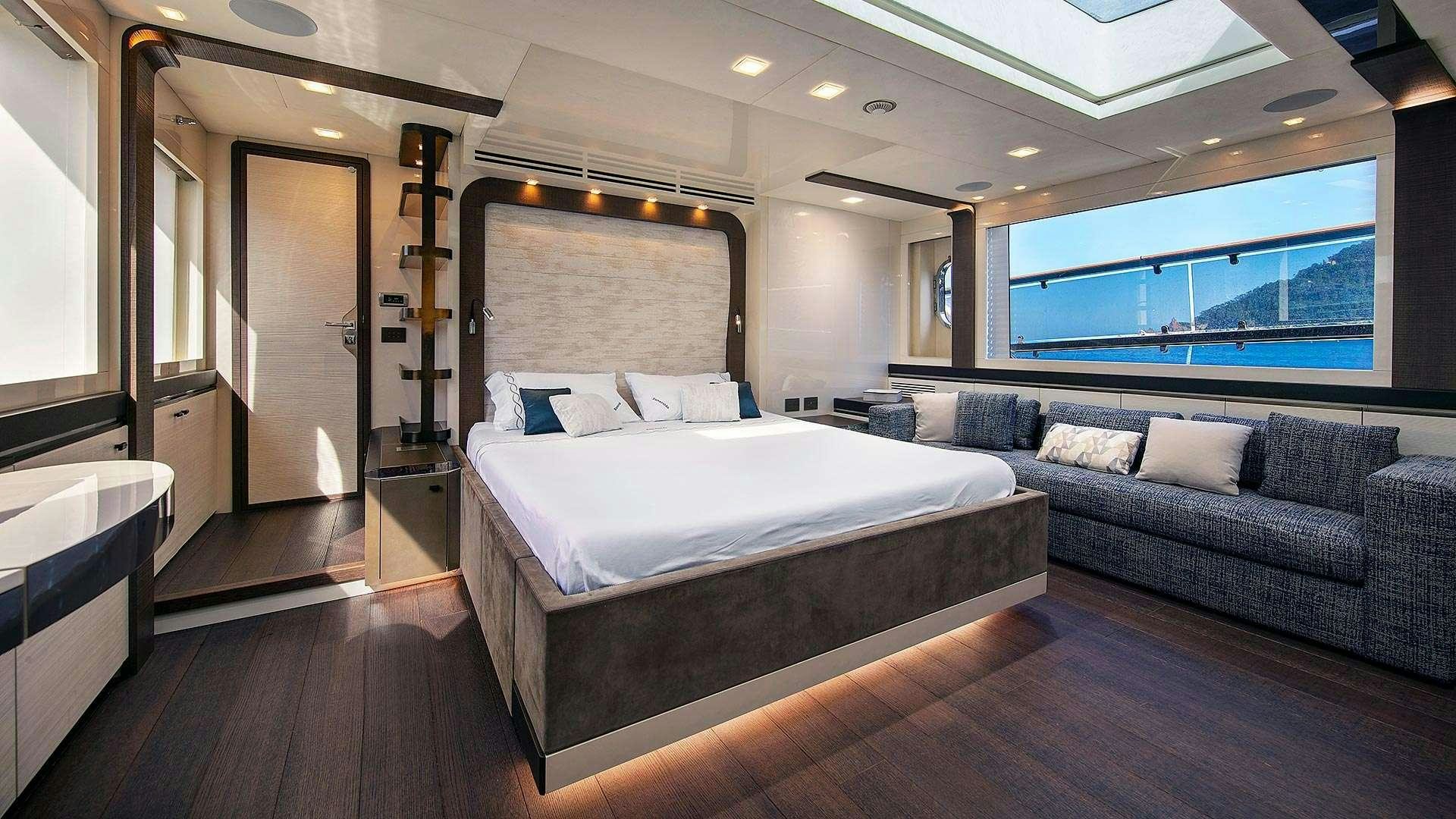 a large bedroom with a bed and a couch aboard ESMERALDA OF THE SEAS Yacht for Charter