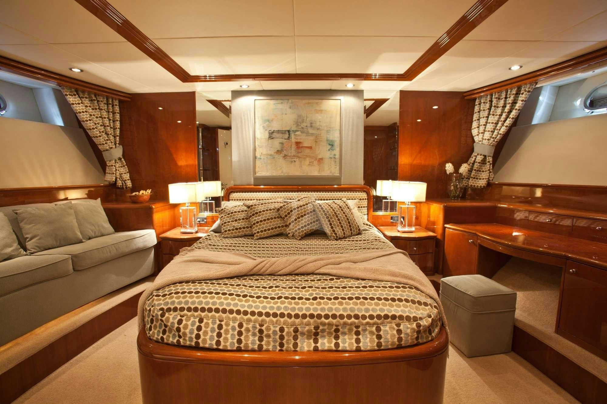 a bed in a room aboard SUPER Yacht for Charter