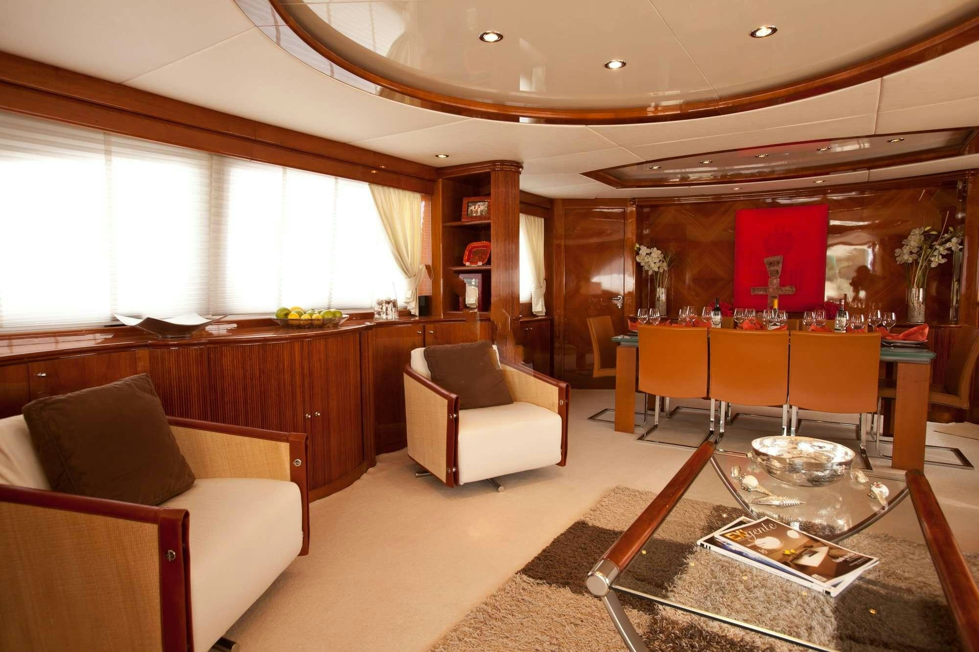 a living room with a table and chairs aboard SUPER Yacht for Charter