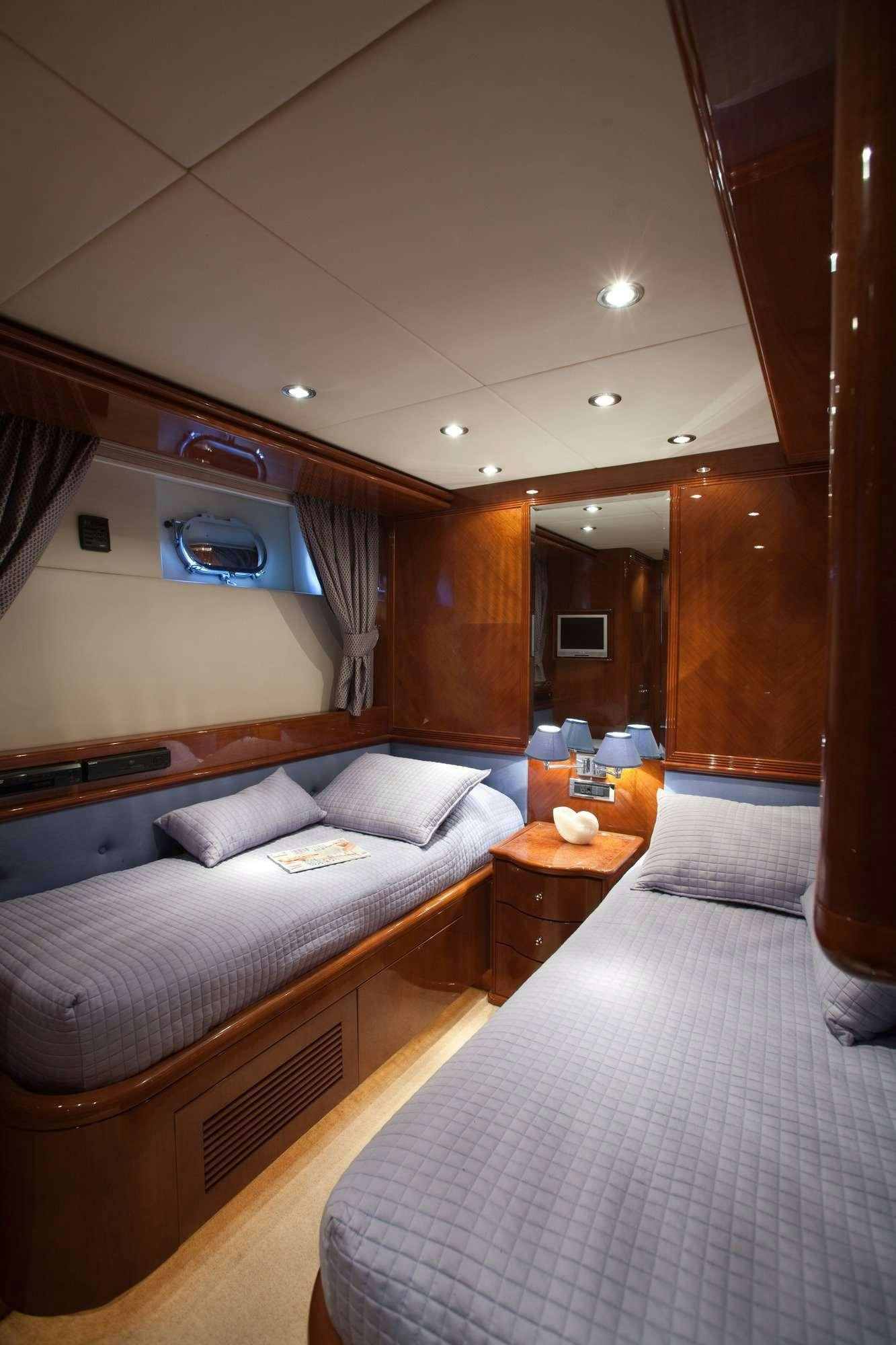 a room with a bed and a desk aboard SUPER Yacht for Charter
