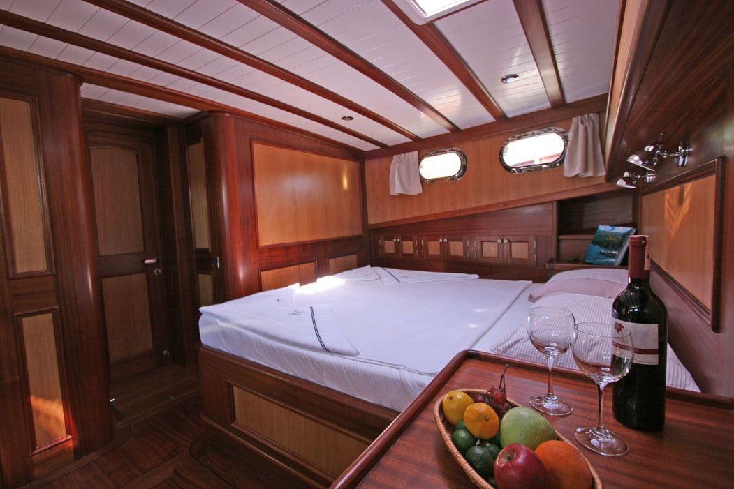 a table with wine glasses and fruit on it aboard HAYAL 62 Yacht for Charter