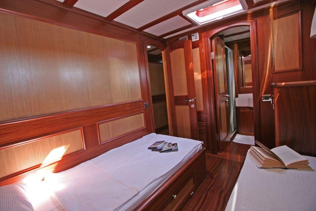 a room with a bed and a desk aboard HAYAL 62 Yacht for Charter