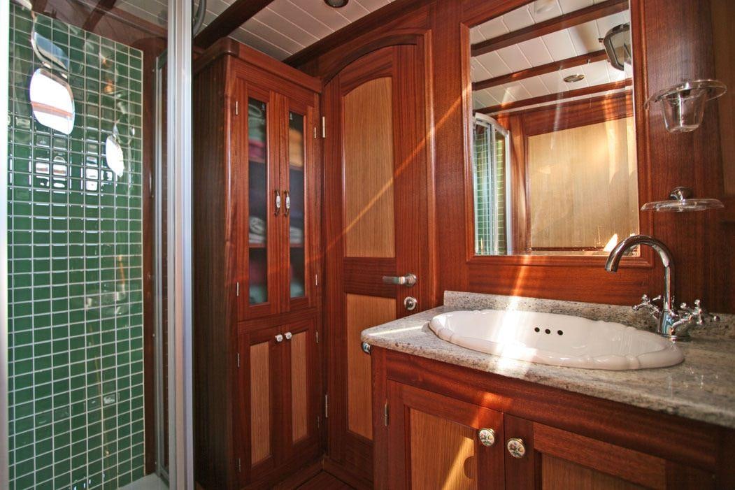 a bathroom with a sink and a mirror aboard HAYAL 62 Yacht for Charter
