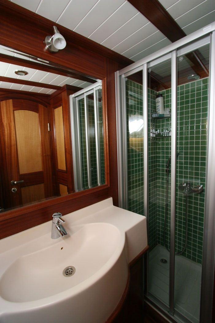 a bathroom with a glass shower aboard HAYAL 62 Yacht for Charter