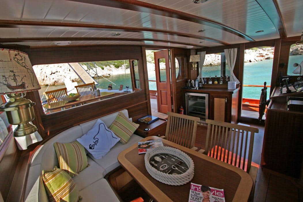 a living room with a large balcony aboard HAYAL 62 Yacht for Charter