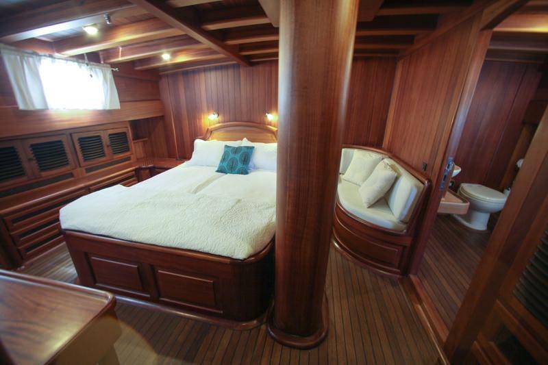 a bed and a chair in a room aboard EYLUL DENIZ II Yacht for Charter