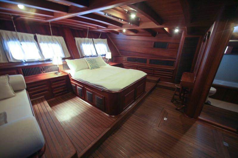 a room with a bed and a window aboard EYLUL DENIZ II Yacht for Charter
