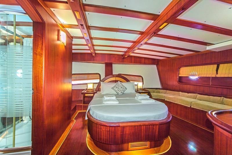 a room with a bed and a table aboard S DOGU Yacht for Charter