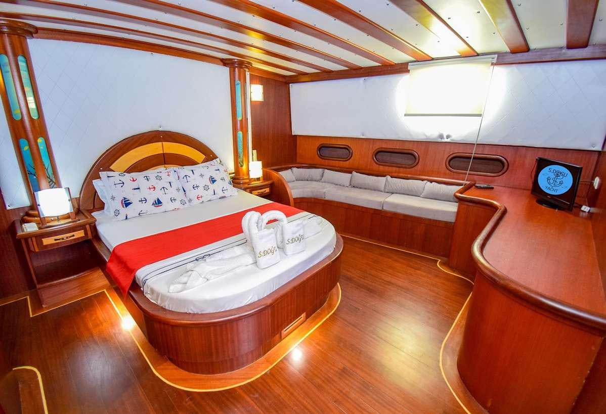 a room with a bed and a table aboard S DOGU Yacht for Charter