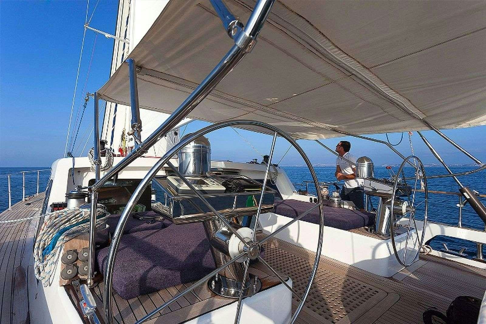 a person sitting on a boat aboard MYOSOTIS Yacht for Charter