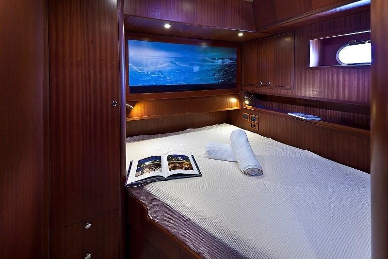 a bed with a laptop on it aboard MYOSOTIS Yacht for Charter