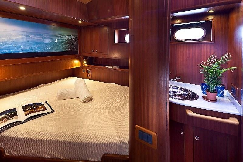 a bedroom with a bed and a desk aboard MYOSOTIS Yacht for Charter