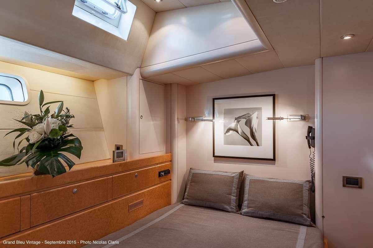 a room with a bed and a picture on the wall aboard GRAND BLEU VINTAGE Yacht for Charter