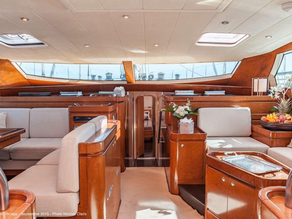 a room with chairs and tables aboard GRAND BLEU VINTAGE Yacht for Charter