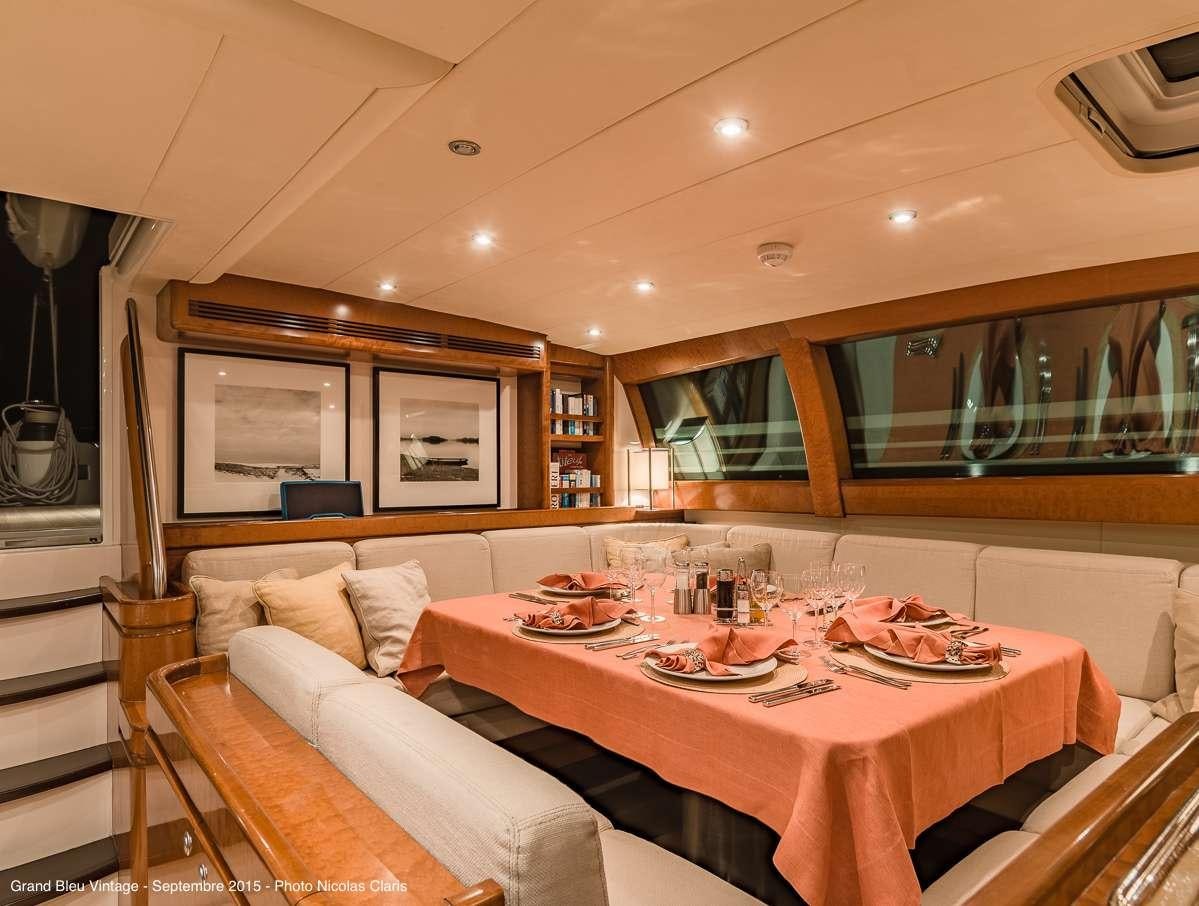 a dining table set for a meal aboard GRAND BLEU VINTAGE Yacht for Charter