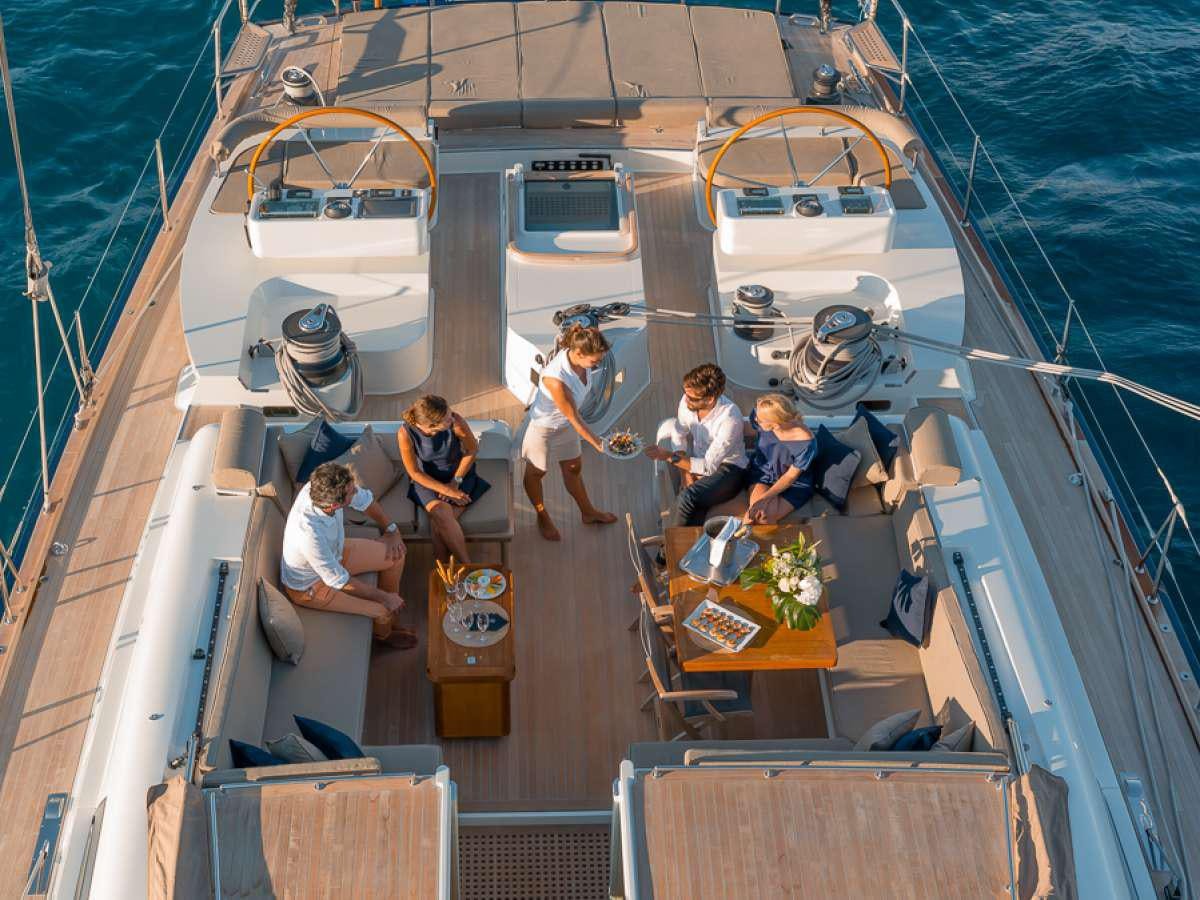 a group of people sitting on a boat aboard GRAND BLEU VINTAGE Yacht for Charter