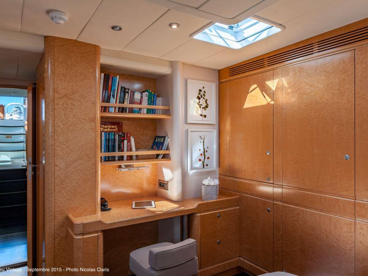 a room with a desk and a bookcase aboard GRAND BLEU VINTAGE Yacht for Charter