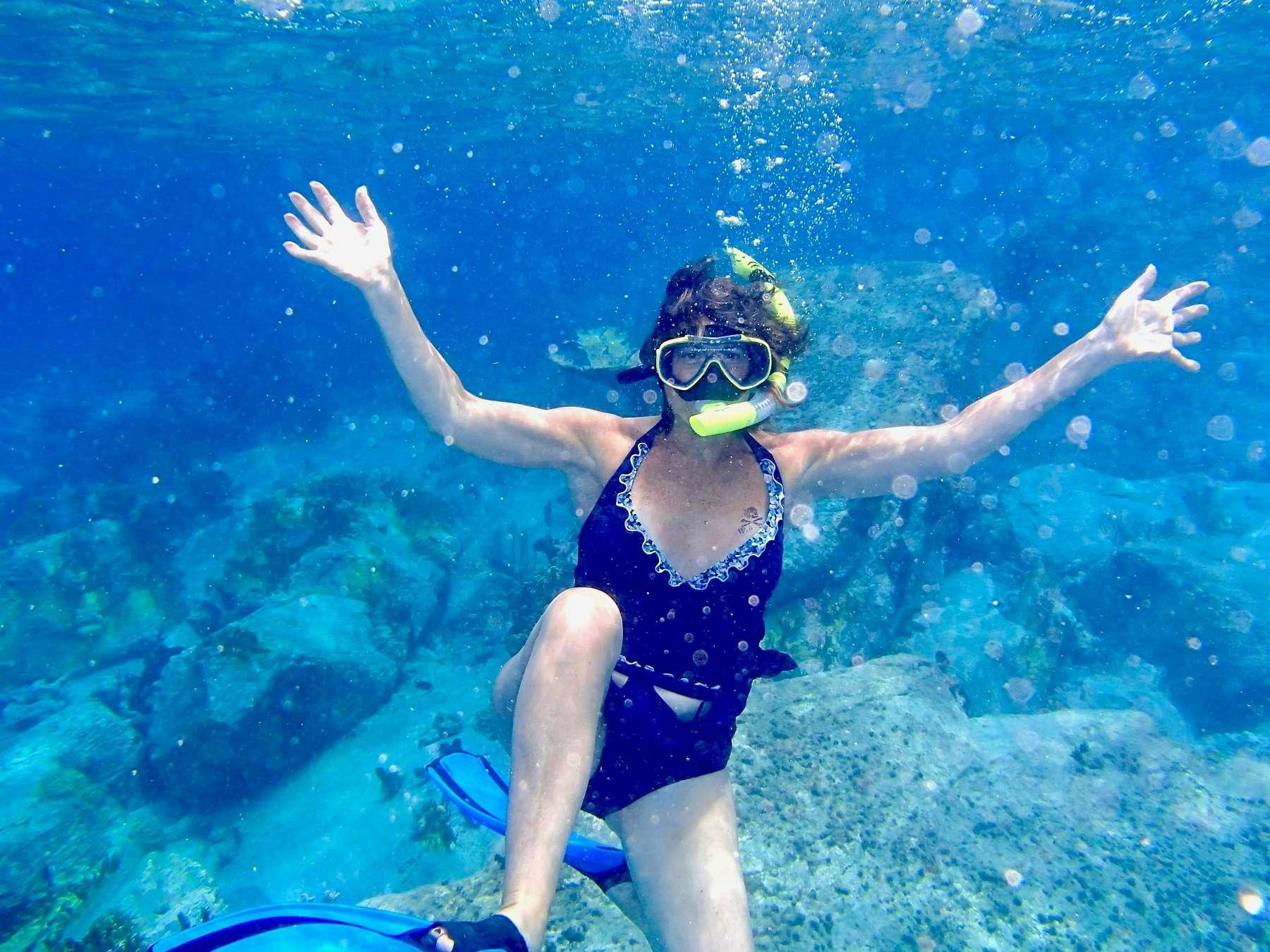 a woman in scuba gear underwater aboard MCGREGOR III Yacht for Charter