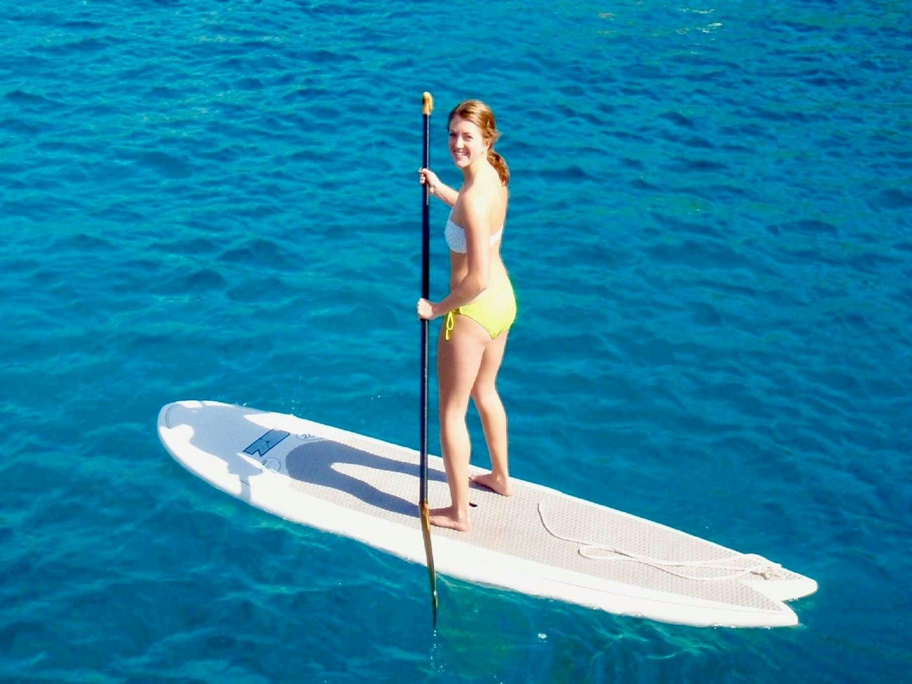 a person standing on a paddle board aboard MCGREGOR III Yacht for Charter