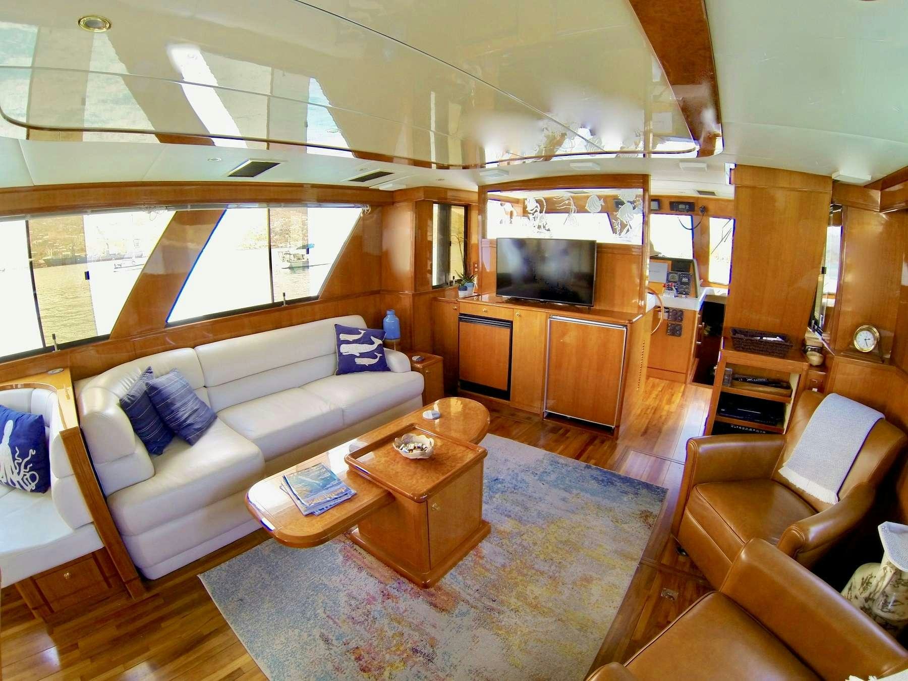 a living room with a couch and a television aboard MCGREGOR III Yacht for Charter