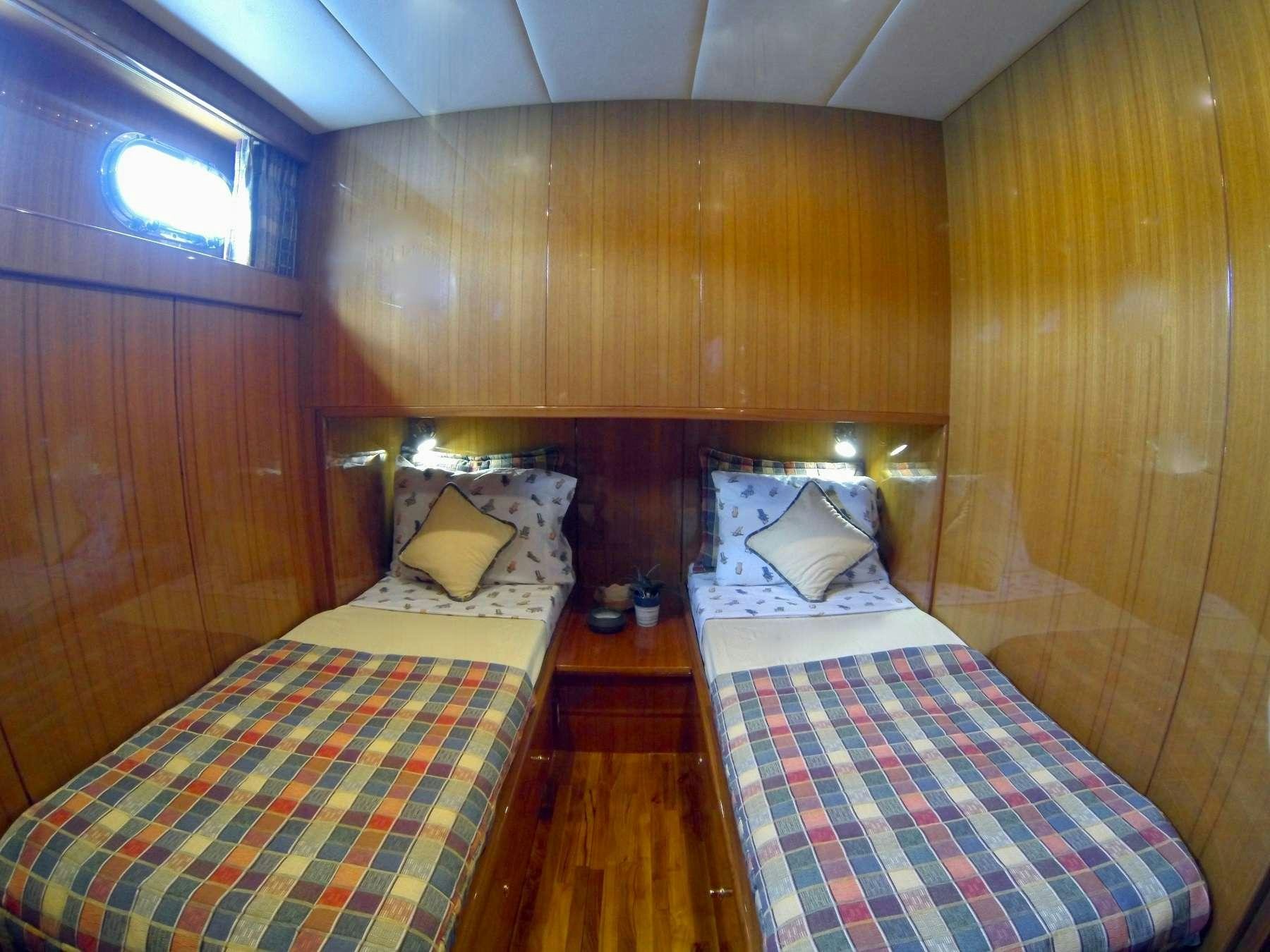 a room with a bed and a wood wall aboard MCGREGOR III Yacht for Charter