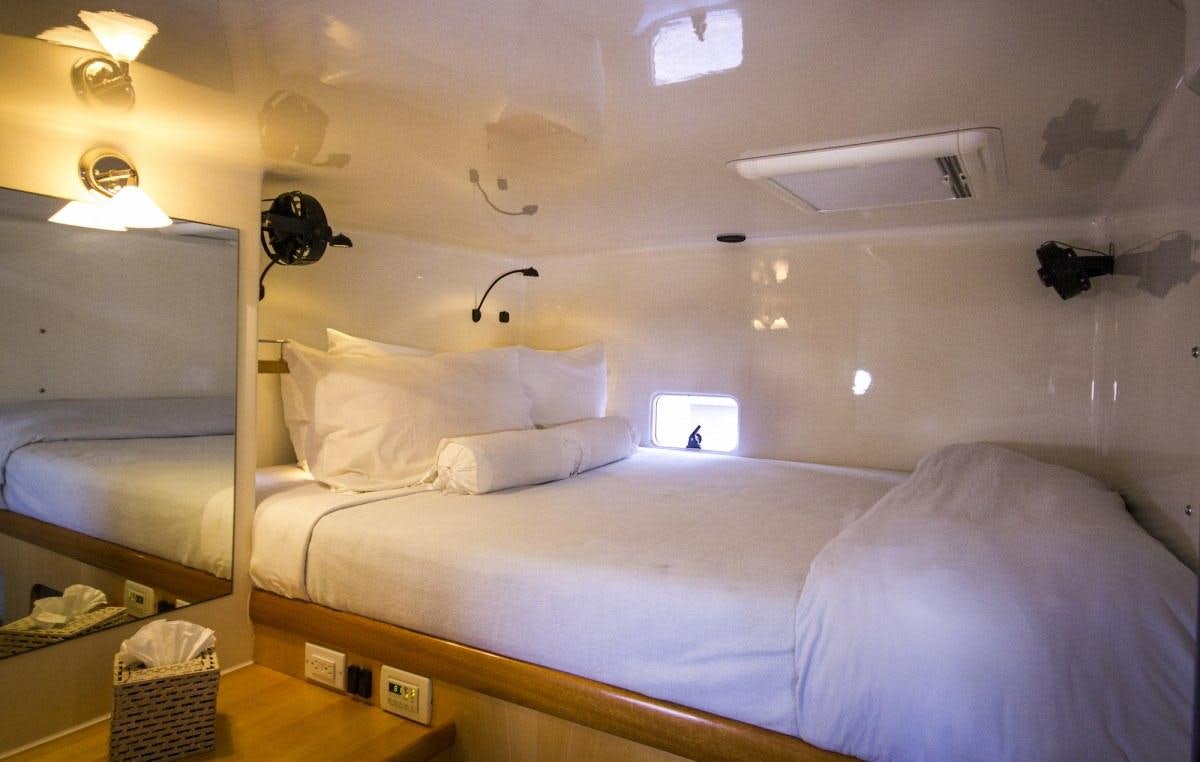 a bedroom with a bed and a desk aboard ZENYATTA Yacht for Charter